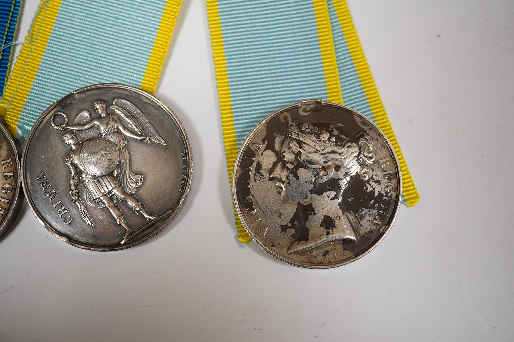 Two Crimea medals, a Baltic medal, all disc only and unnamed with a replica Turkish Crimea medal, unnamed, (3).